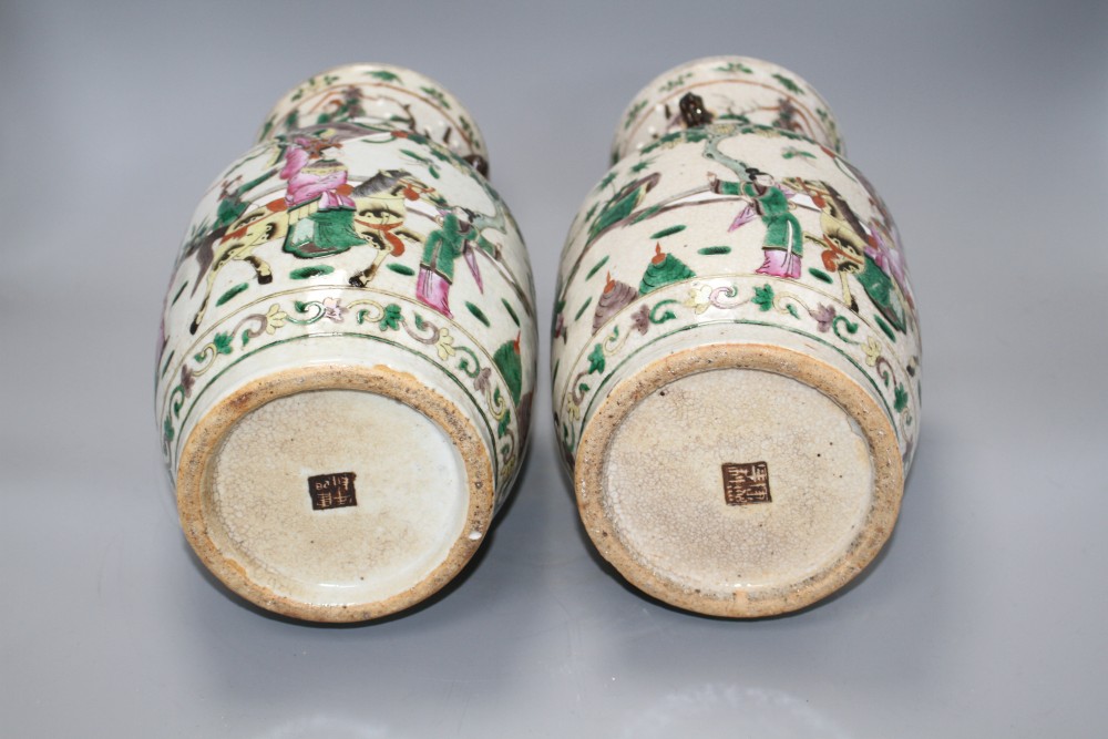 A pair of Chinese crackleware vases, decorated with figures in continuous landscapes, height 33cm